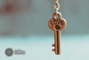Key that says self love with a heart