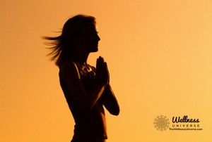 Silhouette of woman with hands together