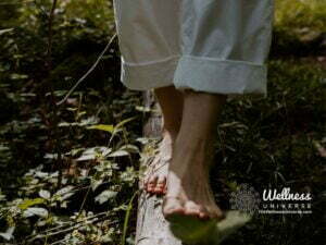 woman walking barefoot on a log