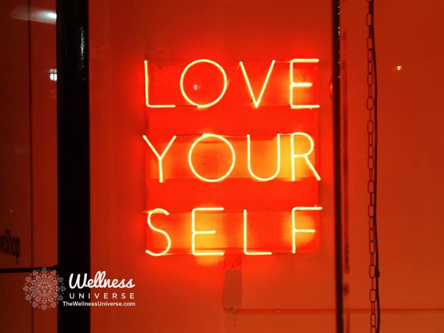neon sign that says love yourself